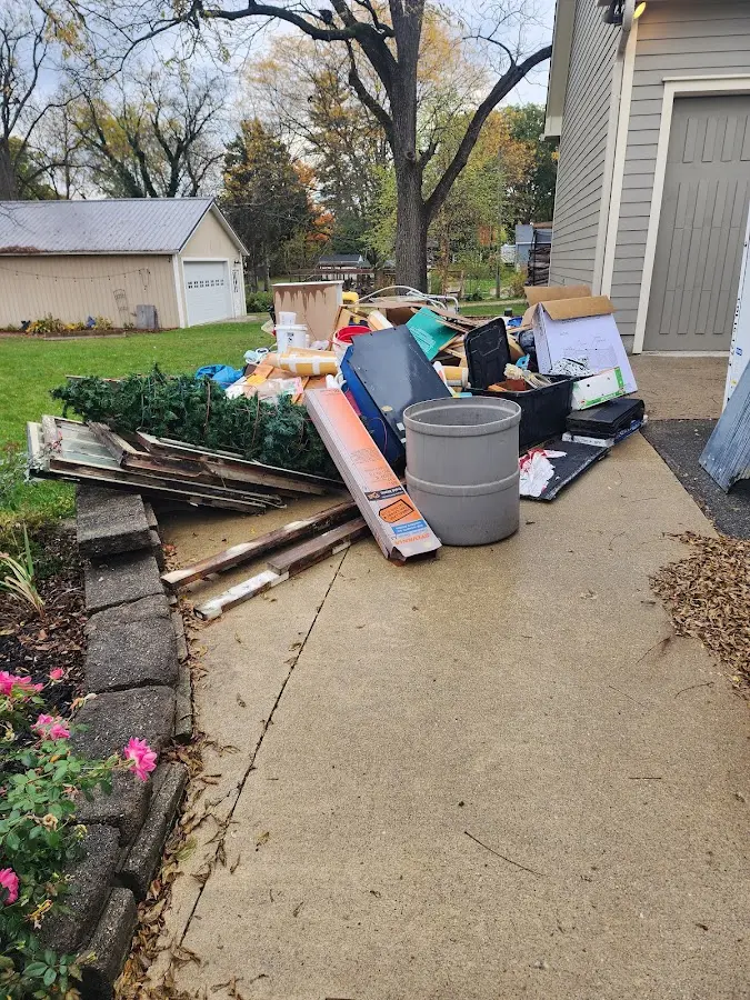 Dumpster being loaded with debris for 12 Yard Dumpster Rental in Princeton